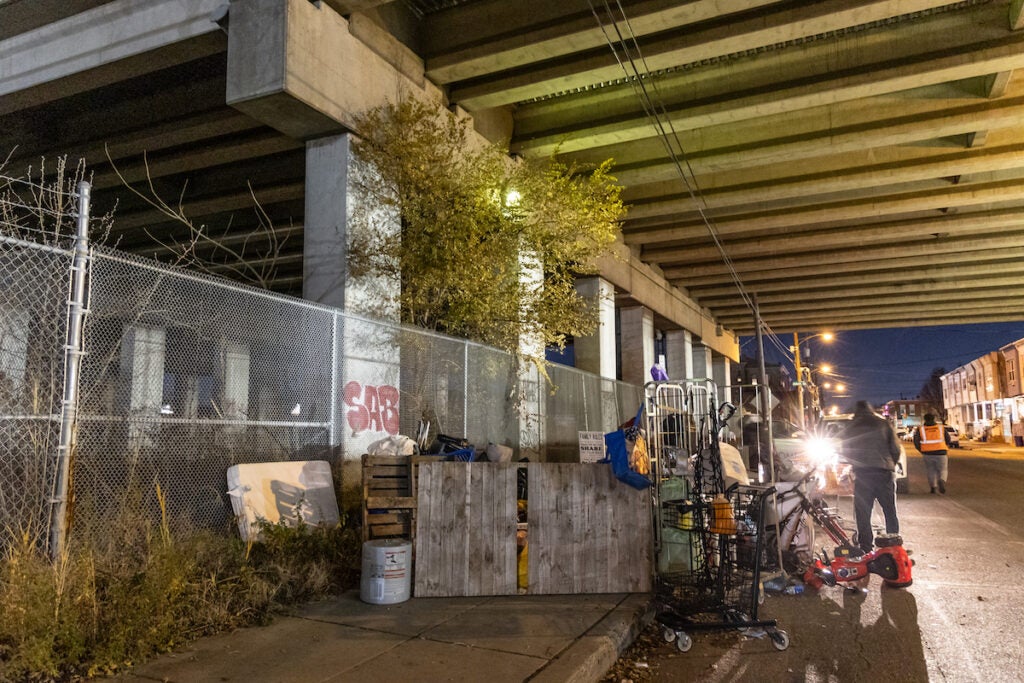 A group of people underneath an overpass.