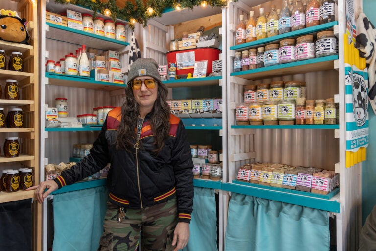 Melissa Lynn Torre, founder of the Vellum Street Soap Company, poses in front of shelves of soaps