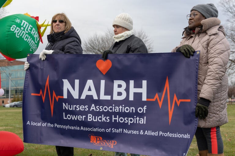 Striking nurses hold a banner that reads NALBH