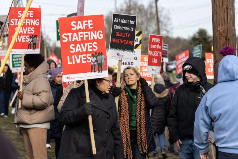 Striking nurses hold signs at the picket line