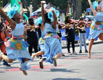 Dancers and musicians on the street during a parade