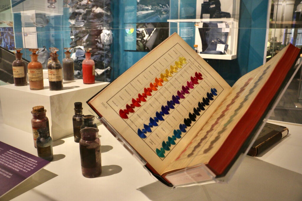 A book with different color threads on display