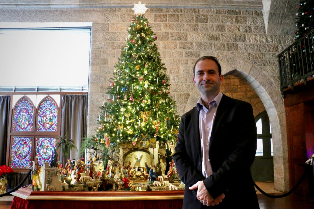 A.J. DiAntonio poses for a photo in front of a nativity scene he created.