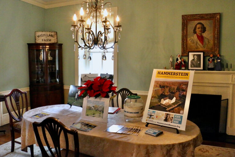 A table is set with pictures and a large newsletter that reads 