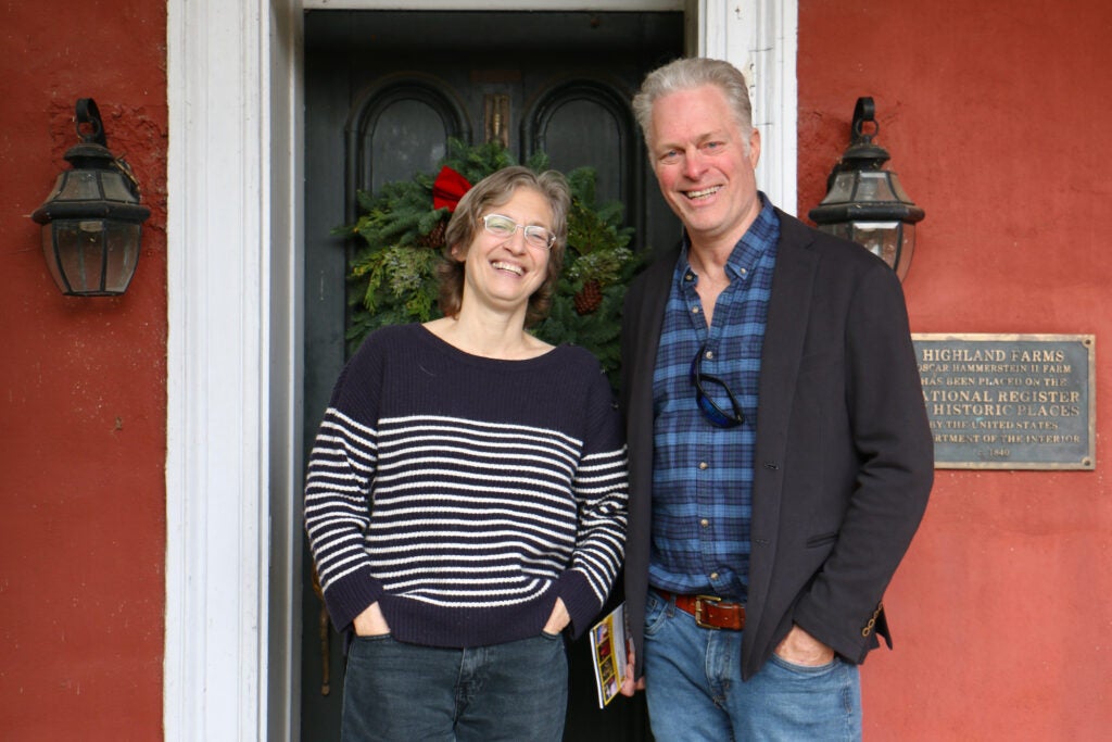 Jennifer Hammerstein, left, and Will Hammerstein, right, stand together for a photo outside of a door.