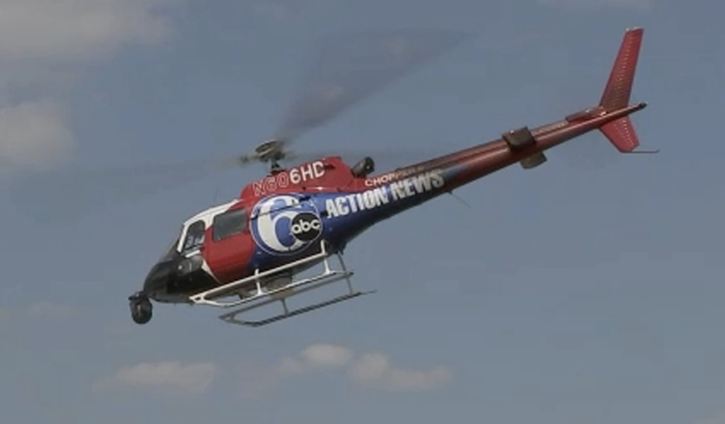 A 6abc helicopter is seen in the sky.