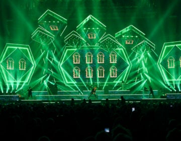 Green lights and members of Trans-Siberian Orchestra performing onstage