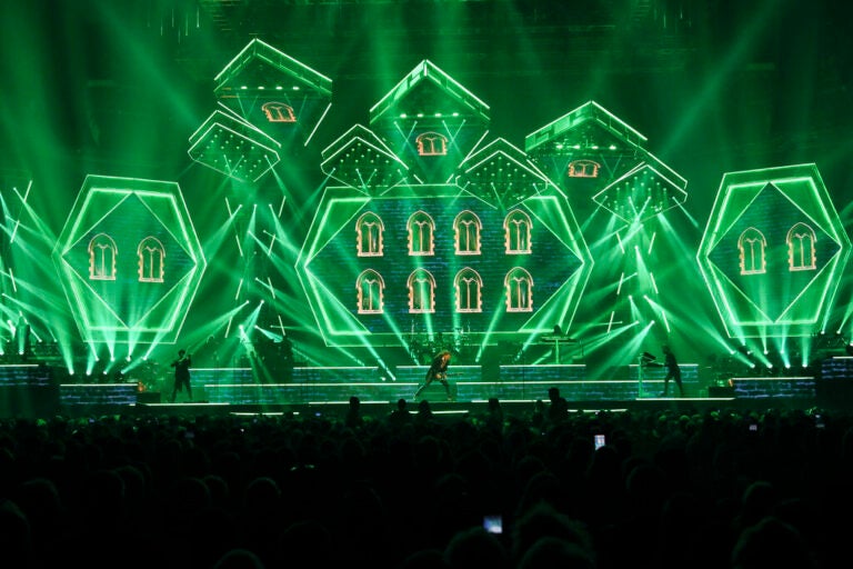 Green lights and members of Trans-Siberian Orchestra performing onstage