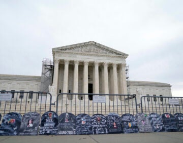 Signs in the shape of grave headstones, with information on people who died from using OxyContin, line a security fence outside the Supreme Court Monday, Dec. 4, 2023, in Washington.The Supreme Court is wrestling with a nationwide settlement with OxyContin maker Purdue Pharma that would shield members of the Sackler family who own the company from civil lawsuits over the toll of opioids. (AP Photo/Stephanie Scarbrough)