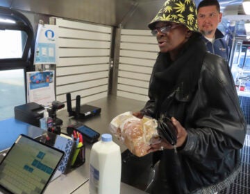 Delorese Butley-Whaley brings her purchases of milk and bread to the register
