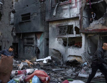 Palestinians look at houses destroyed in the Israeli bombardment of the Gaza Strip in Rafah on Saturday, Dec. 9, 2023.