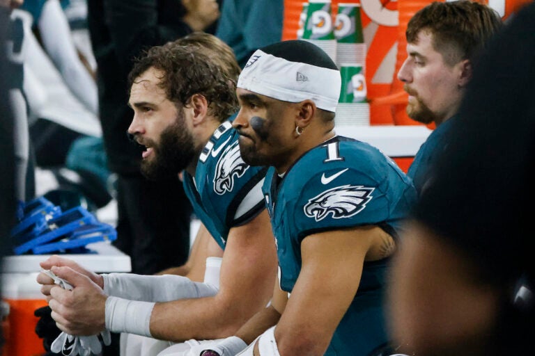 Philadelphia Eagles quarterback Jalen Hurts (1) sits with tight end Dallas Goedert, left, on the bench during the first half of an NFL football game against the Dallas Cowboys, Sunday, Dec. 10, 2023, in Arlington, Texas.