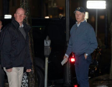 President Joe Biden reacts after hearing a loud bang as he leaves his campaign headquarters in Wilmington, Del., Sunday, Dec. 17, 2023. A car plowed into a parked SUV that was part of Biden's motorcade Sunday night while the president was leaving a visit to his campaign headquarters