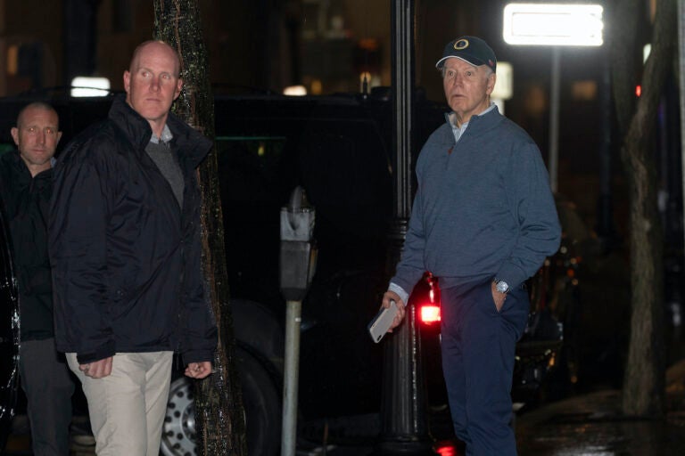 President Joe Biden reacts after hearing a loud bang as he leaves his campaign headquarters in Wilmington, Del., Sunday, Dec. 17, 2023. A car plowed into a parked SUV that was part of Biden's motorcade Sunday night while the president was leaving a visit to his campaign headquarters