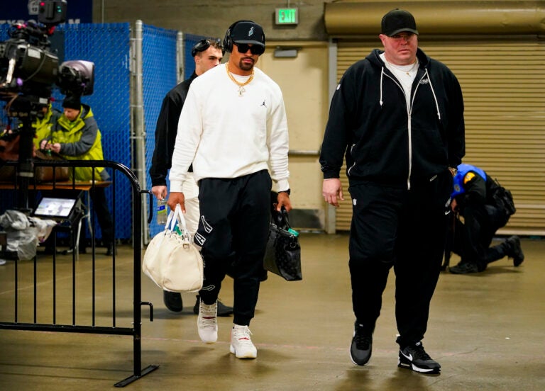 Philadelphia Eagles quarterback Jalen Hurts (left) arrives with chief security officer Dom DiSandro, right, before an NFL football game against the Seattle Seahawks, Monday, Dec. 18, 2023, in Seattle.