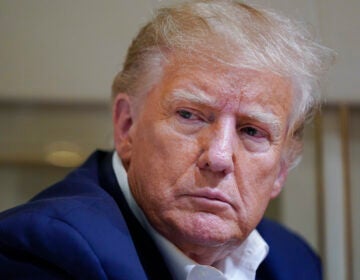 File photo: Former President Donald Trump listens as he speaks with reporters while in flight on his plane after a campaign rally at Waco Regional Airport, in Waco, Texas, March 25, 2023, while en route to West Palm Beach, Fla.