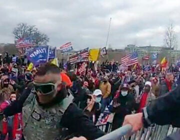 This image from video from a police-worn body camera provided by the Justice Department and contained in the statement of facts shows Samuel Lazar, bottom left, at the U.S. Capitol on Jan. 6, 2021, in Washington. Court documents unsealed this week say that a Pennsylvania man who was sentenced in secret for his role in the U.S. Capitol riot cooperated with authorities investigating the Jan. 6, 2021, attack and an unrelated case. The documents provide insight into the unusual secrecy regarding Samuel Lazar, who was released from federal custody in September after completing his sentence in his Capitol riot case. (Justice Department via AP)