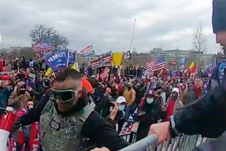 This image from video from a police-worn body camera provided by the Justice Department and contained in the statement of facts shows Samuel Lazar, bottom left, at the U.S. Capitol on Jan. 6, 2021, in Washington. Court documents unsealed this week say that a Pennsylvania man who was sentenced in secret for his role in the U.S. Capitol riot cooperated with authorities investigating the Jan. 6, 2021, attack and an unrelated case. The documents provide insight into the unusual secrecy regarding Samuel Lazar, who was released from federal custody in September after completing his sentence in his Capitol riot case. (Justice Department via AP)