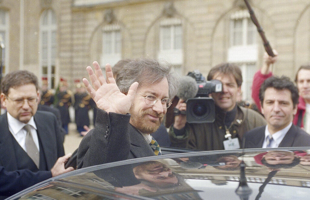 Steven Spielberg in 1994 waves as he exits a vehicle