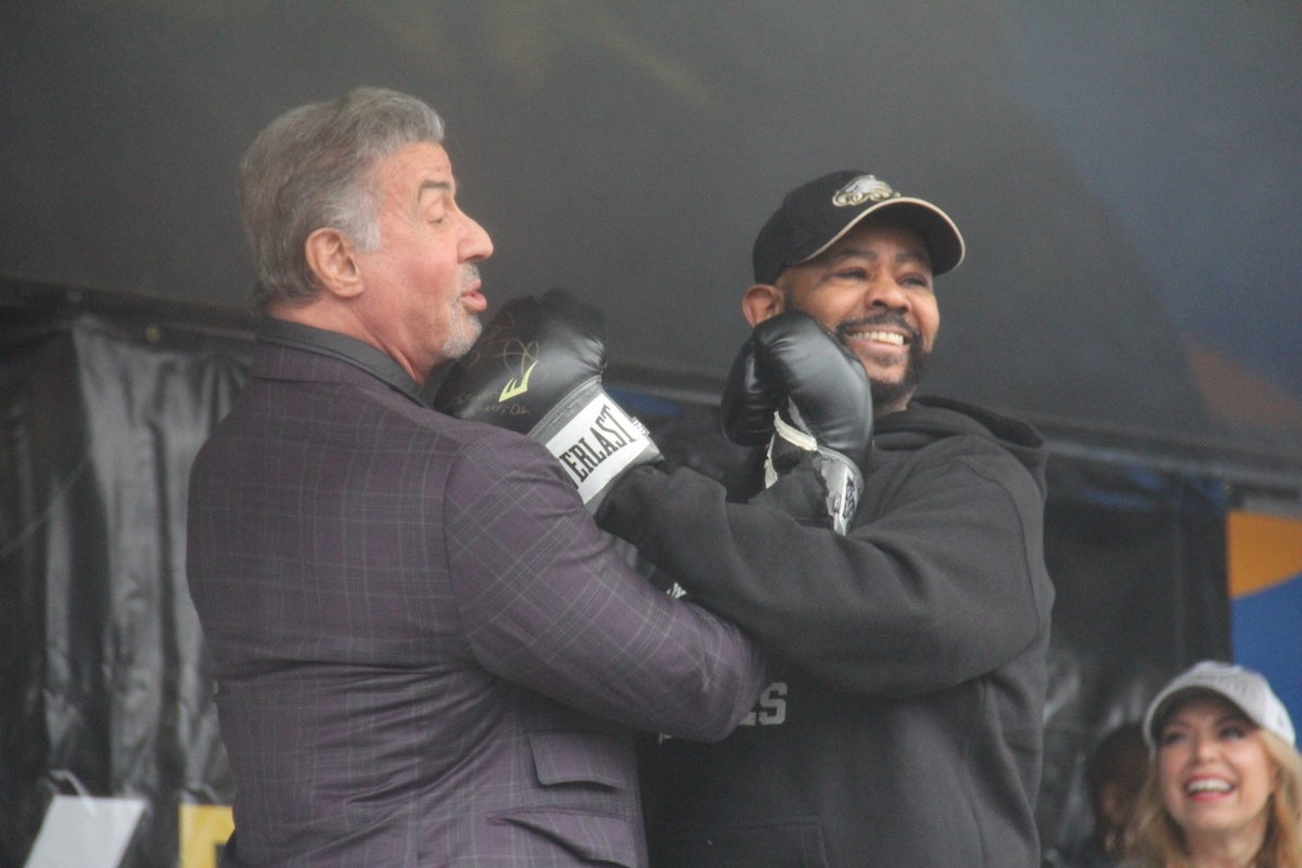 Sylvester Stallone (left) and Councilmember Curtis Jones Jr. (right) traded blows while celebrating Rocky Day on Dec. 3, 2023. (Cory Sharber/WHYY)