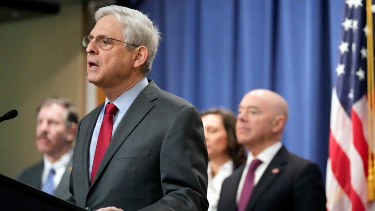 Attorney General Merrick Garland speaks with reporters during a news conference at the Department of Justice on Wednesday as Secretary of Homeland Security Alejandro Mayorkas, right, looks on. Mark Schiefelbein/AP