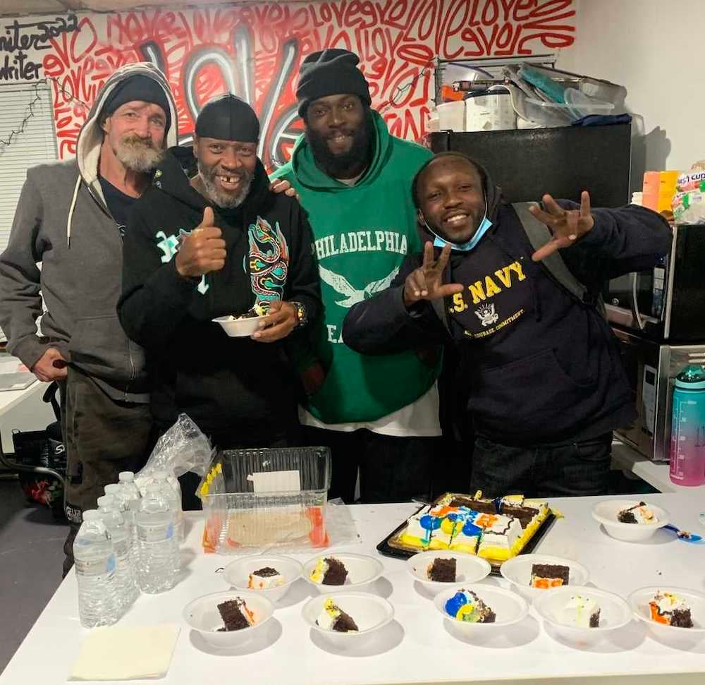 Birthday celebration at Breaking Bread Community with shelter supervisor and former resident, Jonathan Eady (center right)