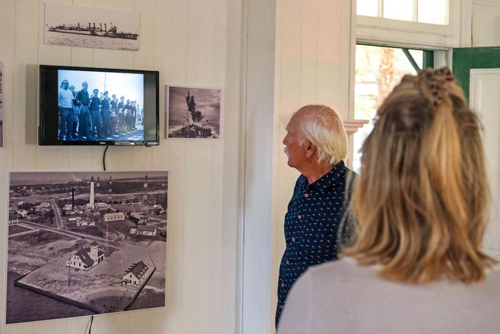 A person looks at things and information hanging on the walls.