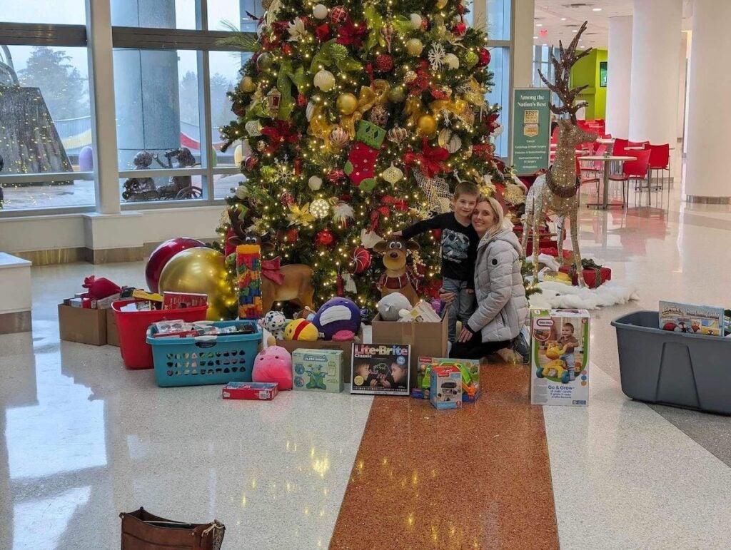 Jessica White and her son Colton White dropping off the toys at the Nemours Children Hospital.