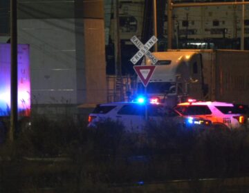 Police on the scene of a partial train derailment