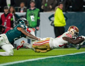 San Francisco 49ers wide receiver Deebo Samuel, right, dives in for a touchdown as Philadelphia Eagles cornerback Darius Slay tries to stop him