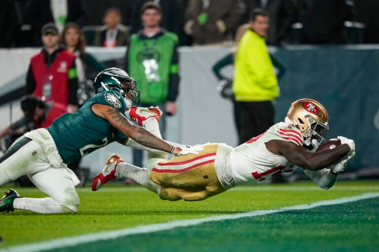 San Francisco 49ers wide receiver Deebo Samuel, right, dives in for a touchdown as Philadelphia Eagles cornerback Darius Slay tries to stop him