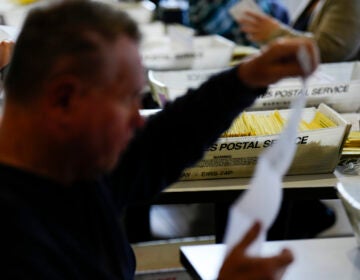 Workers sort mail ballots