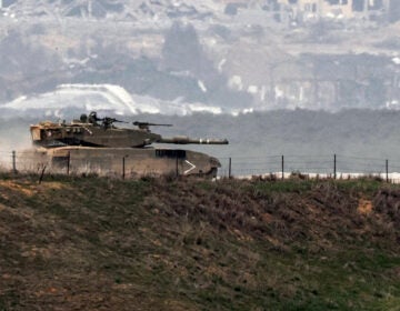 An Israeli battle tank moves along the border between the Gaza Strip and southern Israel on Wednesday as battles between Israel and Hamas continue. (Jack Guez/AFP via Getty Images)