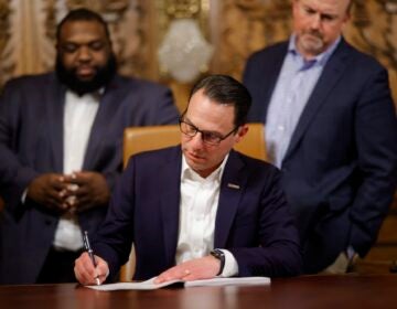 Gov. Shapiro signing a bill at his desk