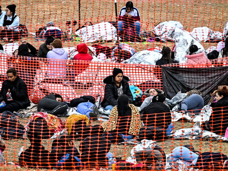 Immigrants wait to be processed at a border patrol transit center.