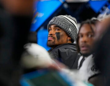 Philadelphia Eagles quarterback Jalen Hurts looks on from the bench