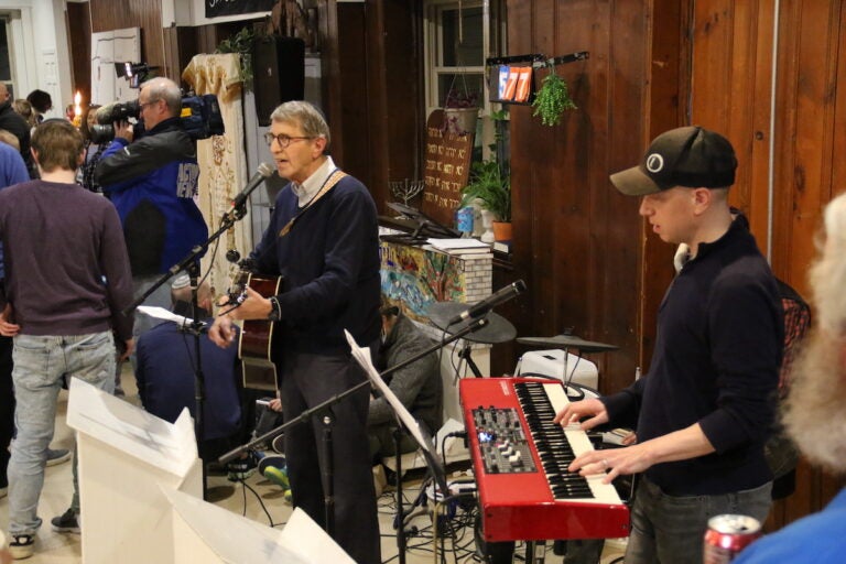 A guitarist and singer and a keyboardist playing together.