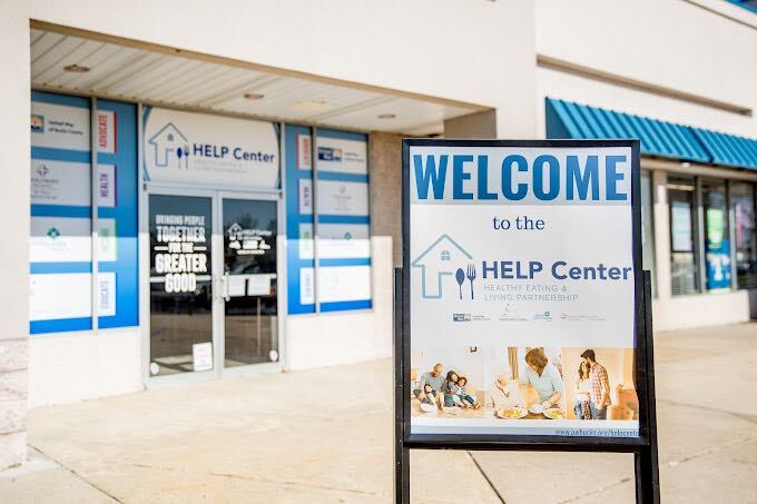 A building with a sign outside that reads Welcome, help center.