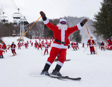 Skiers wearing Santa costumes