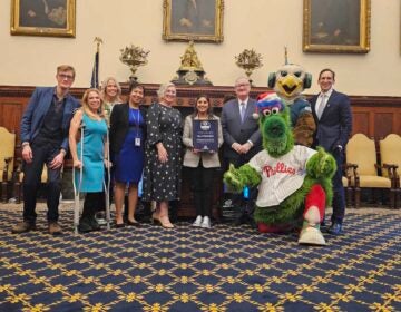 Mayor Kenney, the Phillie Phanatic, and others pose for a photo together in City Hall.