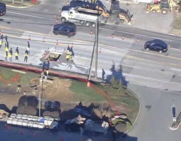 An aerial view of workers repairing a sinkhole