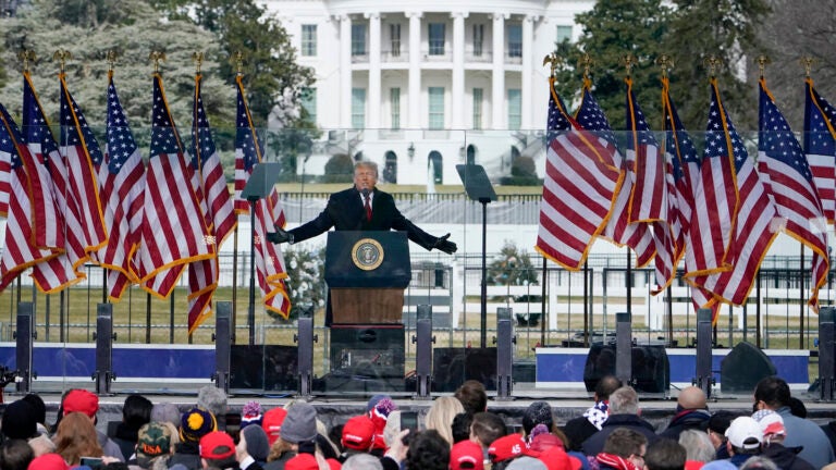 Trump speaks at a podium lined with U.S. flags on Jan. 6.