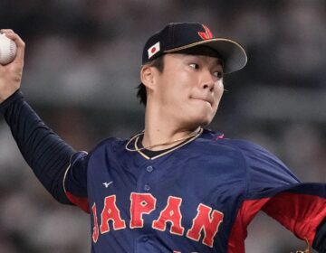 Yoshinobu Yamamoto throws a baseball