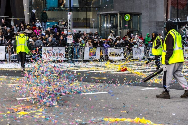 Mummers parade staff use leaf blowers to clear the performance area at City Hall in Philadelphia on Jan. 1, 2024.