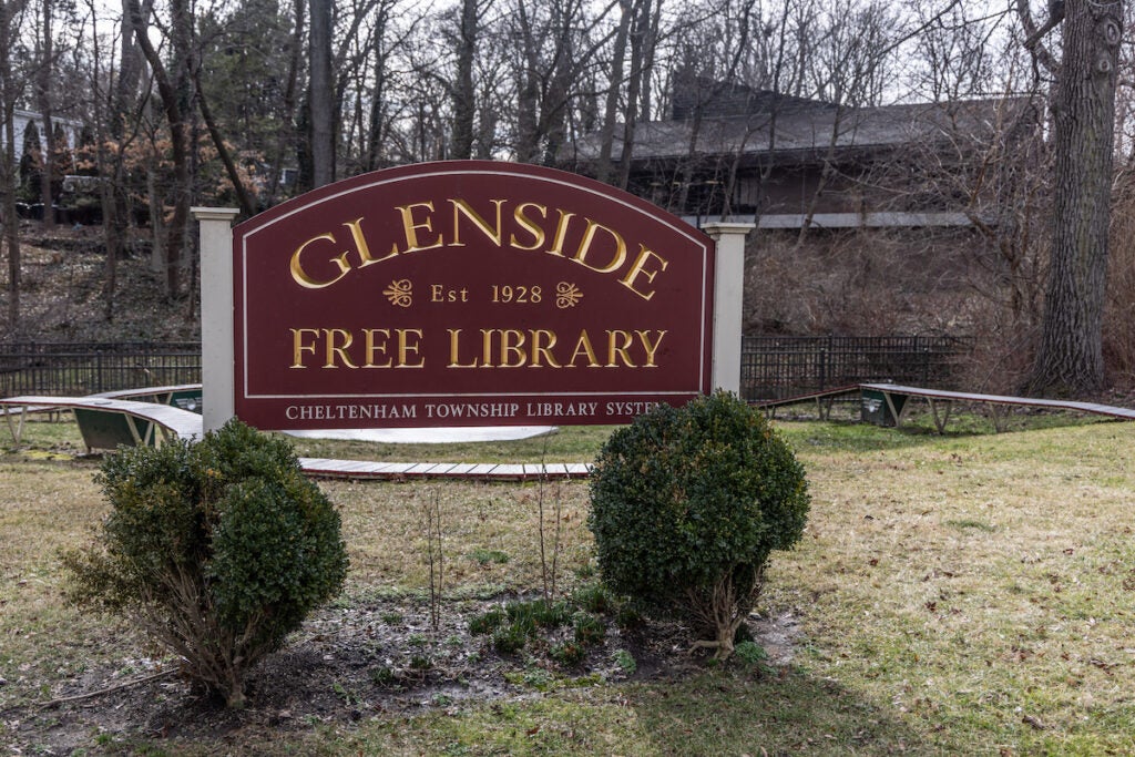 A sign reads Glenside Free Library. A building and trees are visible in the background.
