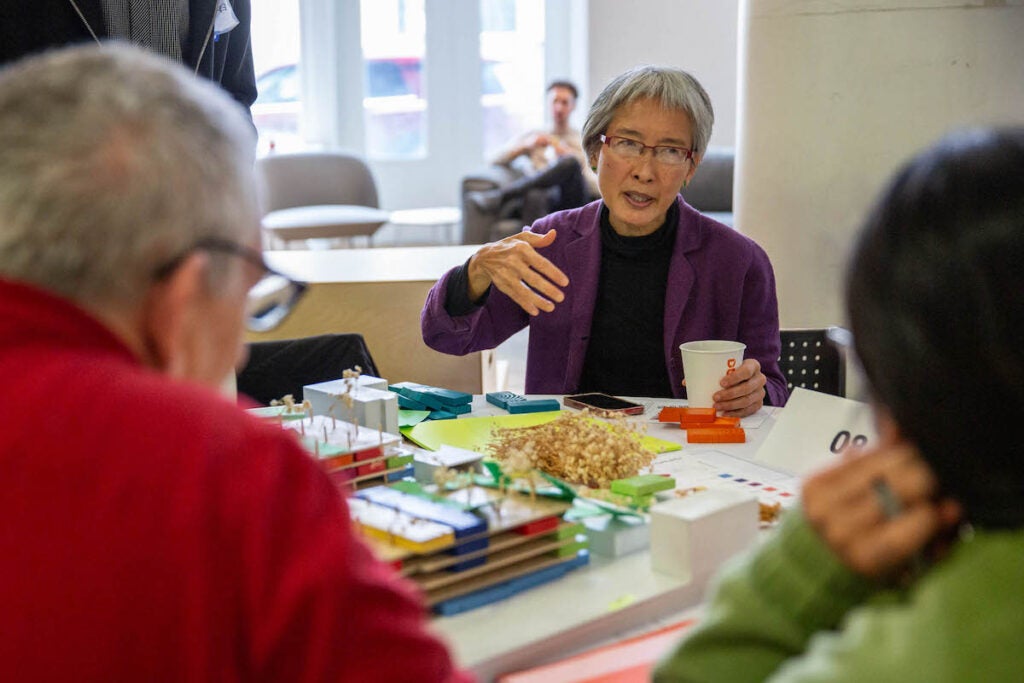 People speak together at a table.