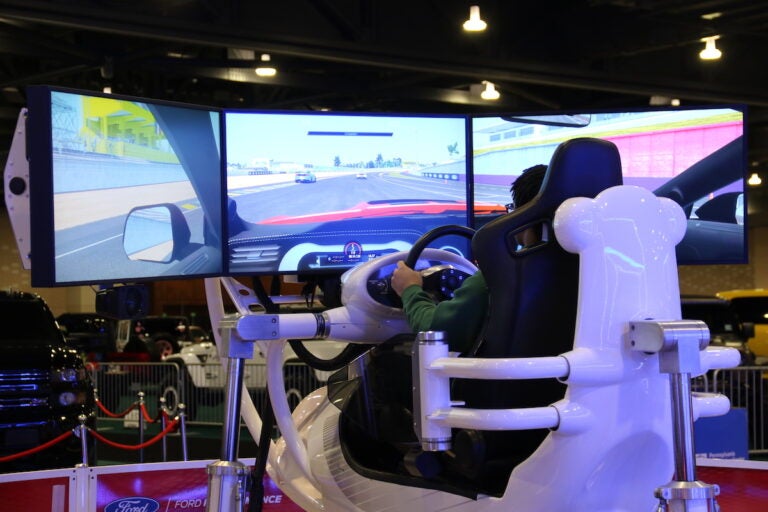 No, this attendee isn't partaking in a flight simulator, but rather the Ford Performance Simulator that allows people to feel what it's like to drive on a challenging road course.