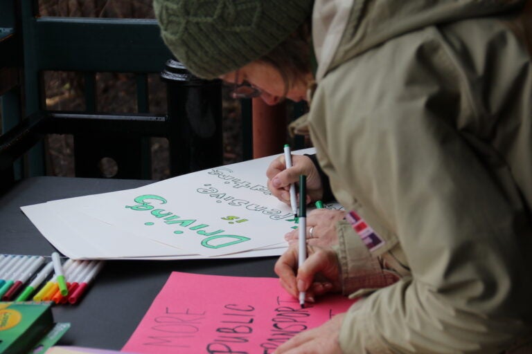 Community members across all ages made signs and showed their support for the Chestnut Hill West Regional Line during a ''rally and ride'' at the Richard Allen Lane SEPTA station on Jan. 28, 2024. (Cory Sharber/WHYY)