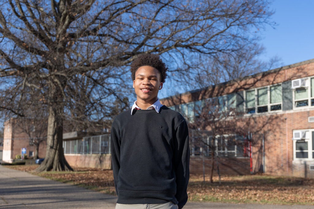 Joshua Scotland, 17, poses for a photo outside of Northeast High School