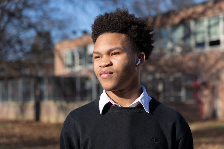 Joshua Scotland poses for a photo outside of Northeast High School